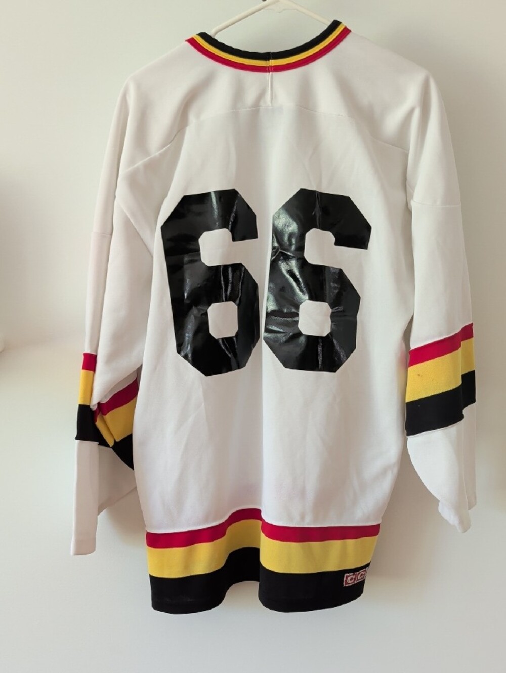 Vintage 90s CCM Hockey Jersey - White with Red/Yellow/Black #66 In Back XL